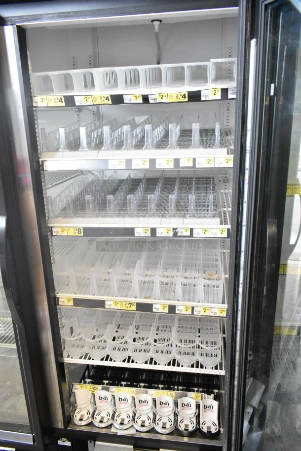 2017 True GDM-72-HC 3-door commercial cooler, reach-in style, displaying interior shelves and price tags, excellent condition.