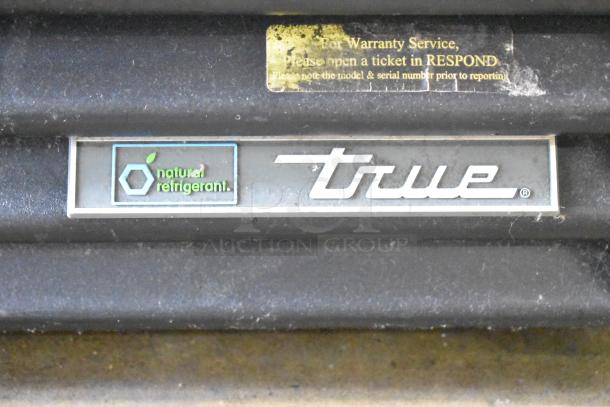 "True logo with natural refrigerant label on 2017 True GDM-72-HC Commercial 3 Door Reach In Cooler Merchandiser."