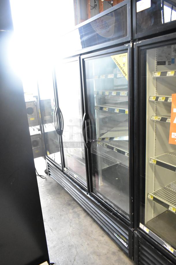 2017 True GDM-72-HC commercial 3-door reach-in cooler, 115 volts, 1 phase; features glass doors and interior shelving.