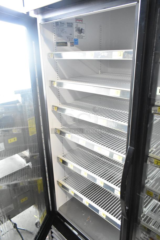 2017 True GDM-72-HC commercial 3-door reach-in cooler, 115 volts, 1 phase, empty shelves, clear label with model info.