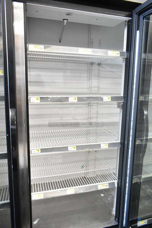 2017 True GDM-72-HC 3-door reach-in cooler merchandiser, 115 volts, 1 phase, metal shelves, in good condition.