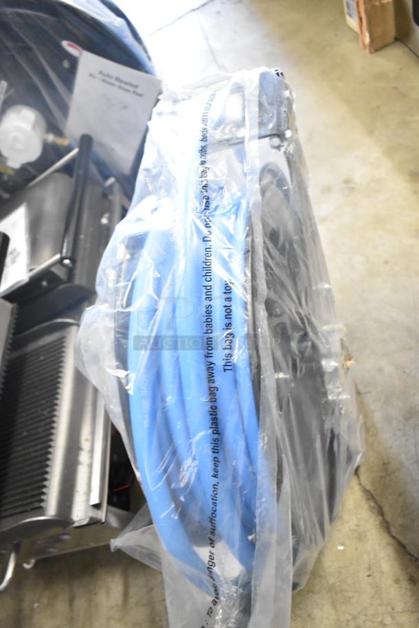 BRAND NEW Regency 600HRPC38100 hose reel with 100' x 3/8" hose, powder-coated steel, in protective packaging, minor scratches.