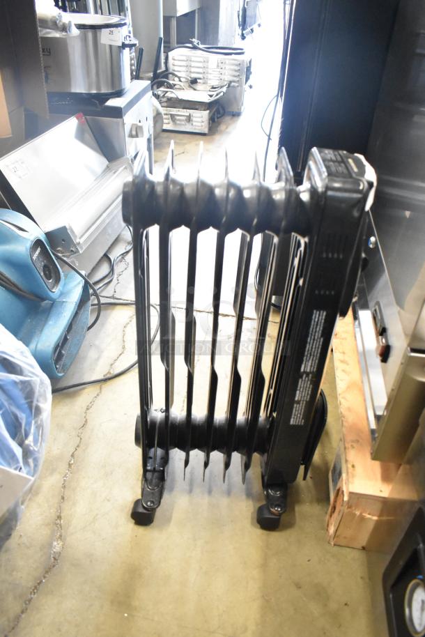 Utililtech CYWE08-7 oil-filled radiator, 120 volts, black, on wheels. Appears in good condition.