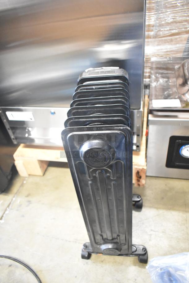 Utilitech CYWE08-7 oil-filled radiator, 120V, black metal; portable design with castors; excellent condition.