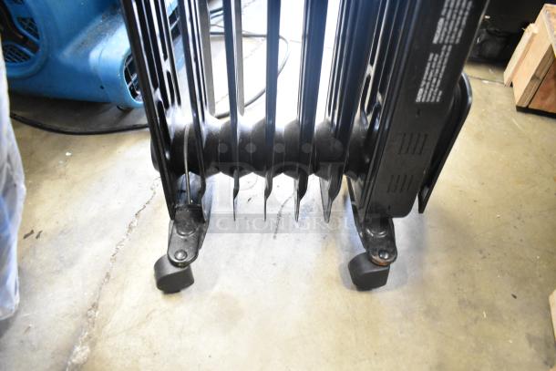 Utililtech CYWE08-7 oil-filled radiator, 120V, 1 phase, black, wheeled base, visible instructions and power cord.