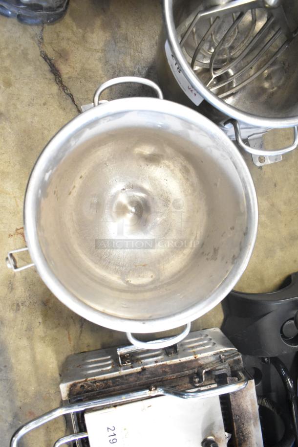 Two commercial stainless steel mixing bowls with handles, two paddle attachments. Used condition. Auction lot includes four pieces.