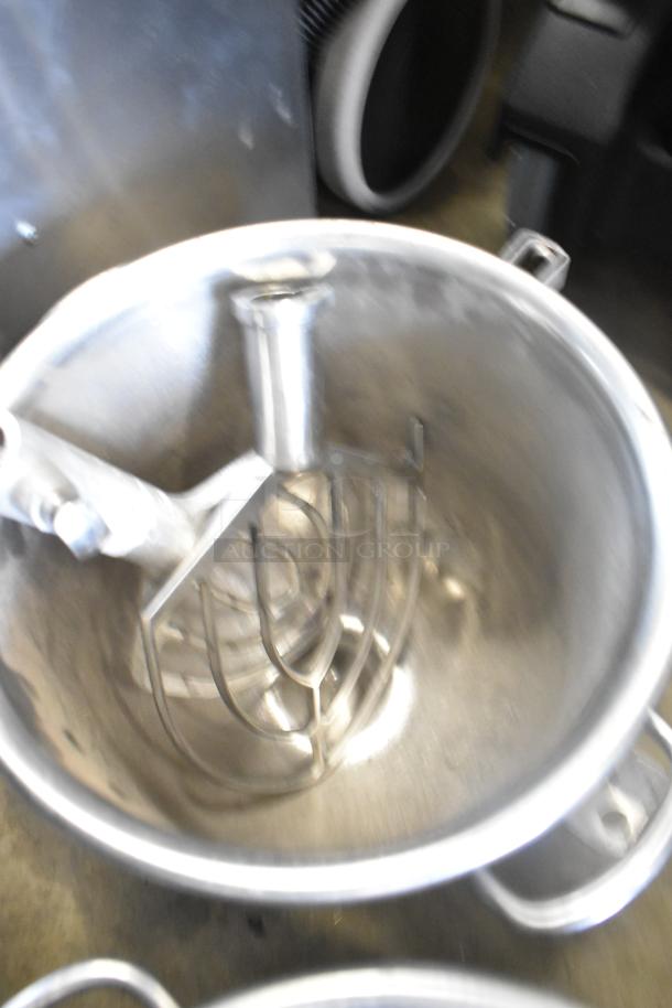 Two commercial mixing bowls with two paddle attachments in stainless steel, industrial-grade condition, ideal for heavy-duty use.