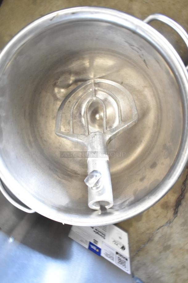 Two commercial mixing bowls with attached paddle, stainless steel, visible wear. Includes QR code and paper tags.