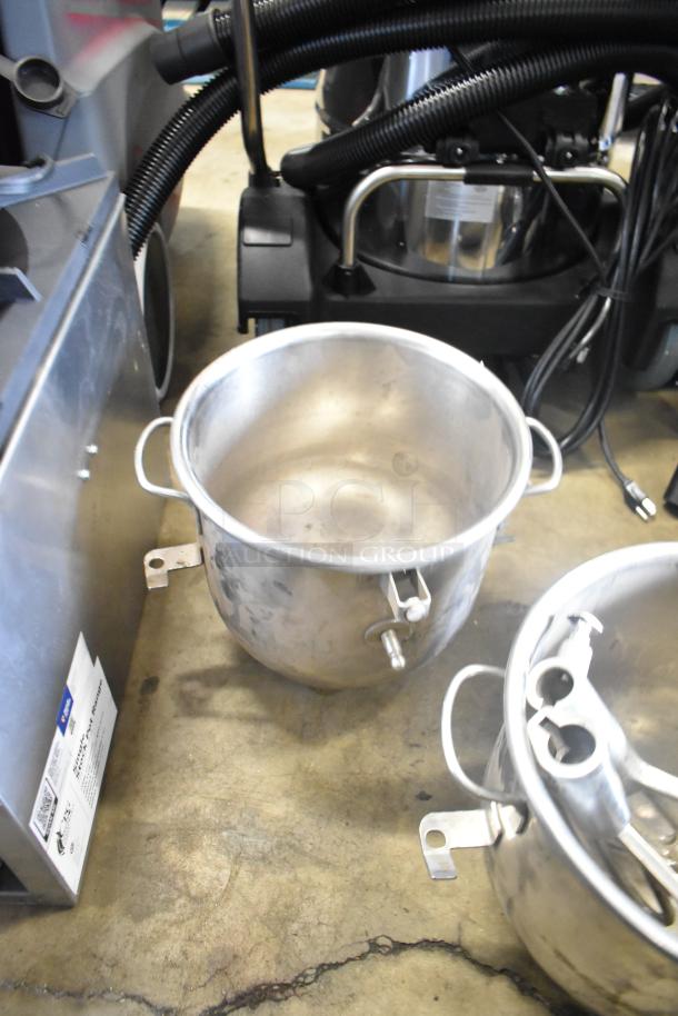 Four kitchen items: two commercial mixing bowls with handles and attachments, showing signs of wear.