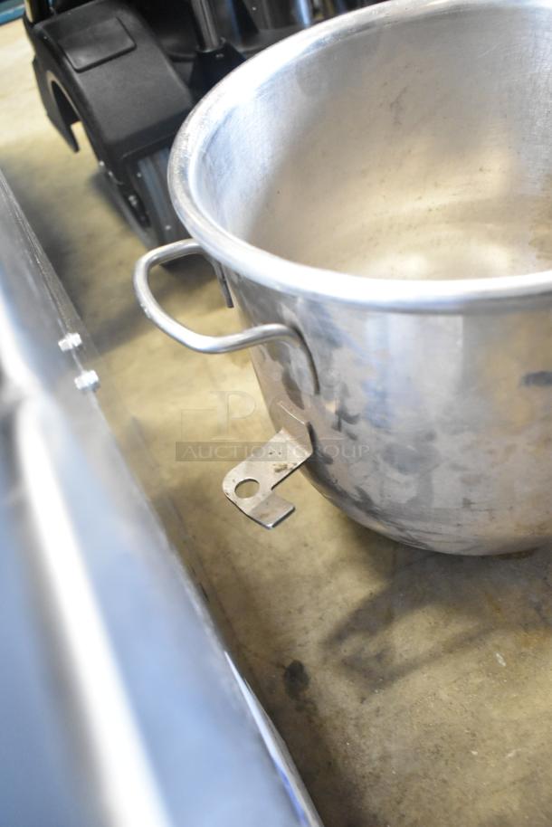 Two commercial mixing bowls with handles, stainless steel, light wear, auction includes two paddle attachments.