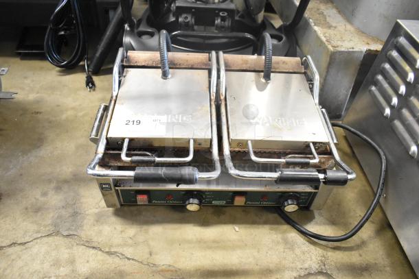 Waring WPG300 commercial double panini press, 240 volts, countertop model, showing signs of wear, stainless steel construction.