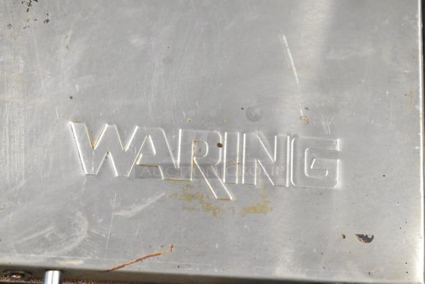 Waring WPG300 Commercial Panini Press, stainless steel, embossed with "Waring" logo, used condition.