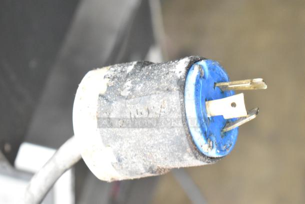 Alt text: Close-up of a plug for the 2021 Middleby Marshall PS638G conveyor pizza oven, featuring a worn and slightly dirty exterior.