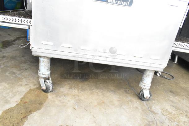 Middleby Marshall PS638G conveyor pizza oven on casters, showcasing used condition and natural gas connection.