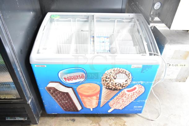 AHT RIO S 100 ice cream freezer with Nestlé branding, sliding glass top, on commercial casters, 115V, 1 Phase.