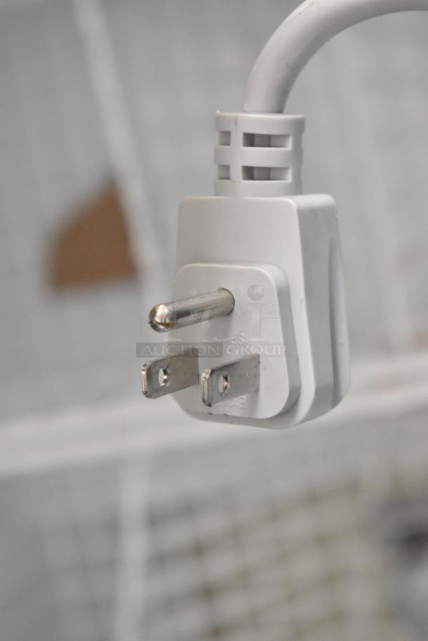 Close-up of a three-prong electrical plug for AHT RIO S 100 ice cream freezer. Durable, standard US voltage plug.