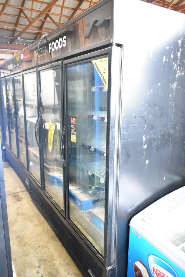 2017 True GDM-72F-HC commercial 3-door reach-in freezer, 115/208-230V, visible promotional and payment acceptance signage.