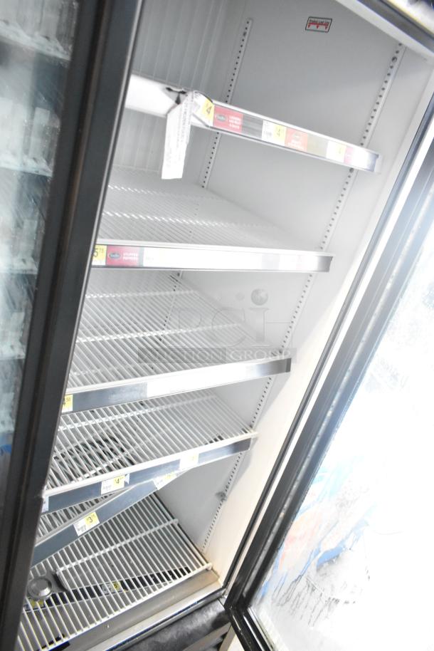 2017 True GDM-72F-HC commercial 3-door reach-in freezer, empty shelves, visible labels, 115/208-230V, 1 phase.