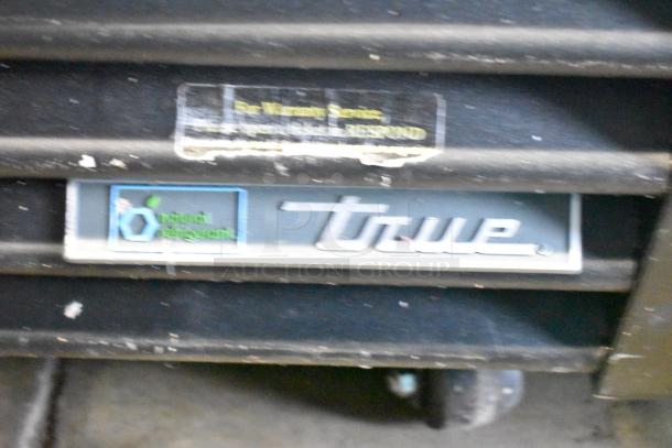 2017 True GDM-72F-HC freezer label, showing True logo and “natural refrigerant” text. Visible wear on surface.