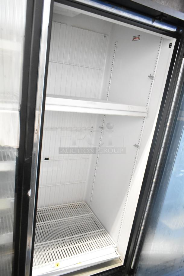 2017 True GDM-72F-HC commercial 3-door reach-in freezer. Clean interior, white shelving. Model tag visible.