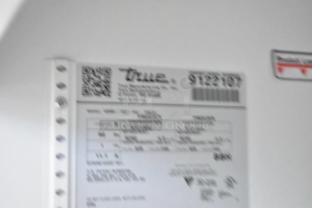 Blurred image of a label inside a 2017 True GDM-72F-HC commercial freezer, showing model and voltage details.