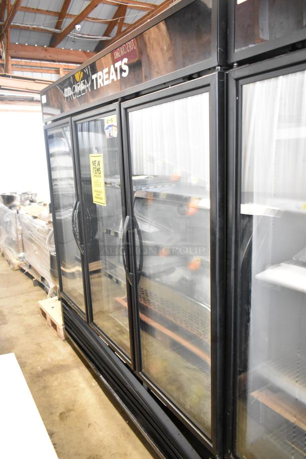 2017 True GDM-72F-HC 3-door commercial freezer merchandiser, black, with glass doors, labels, and "Frozen Treats" header.