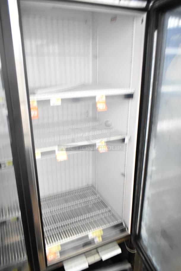 2017 True GDM-72F-HC commercial freezer with three glass doors, shelves, and visible price tags. 115/208-230 Volts, 1 Phase.