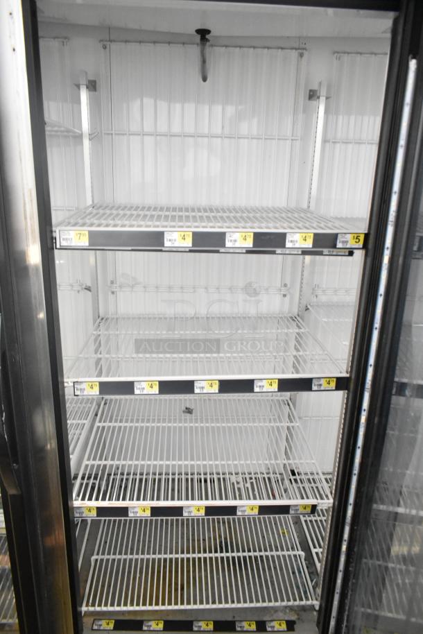 2017 True GDM-72F-HC 3 Door Commercial Freezer. Features multiple wire shelves, clean interior, and clear labeling.