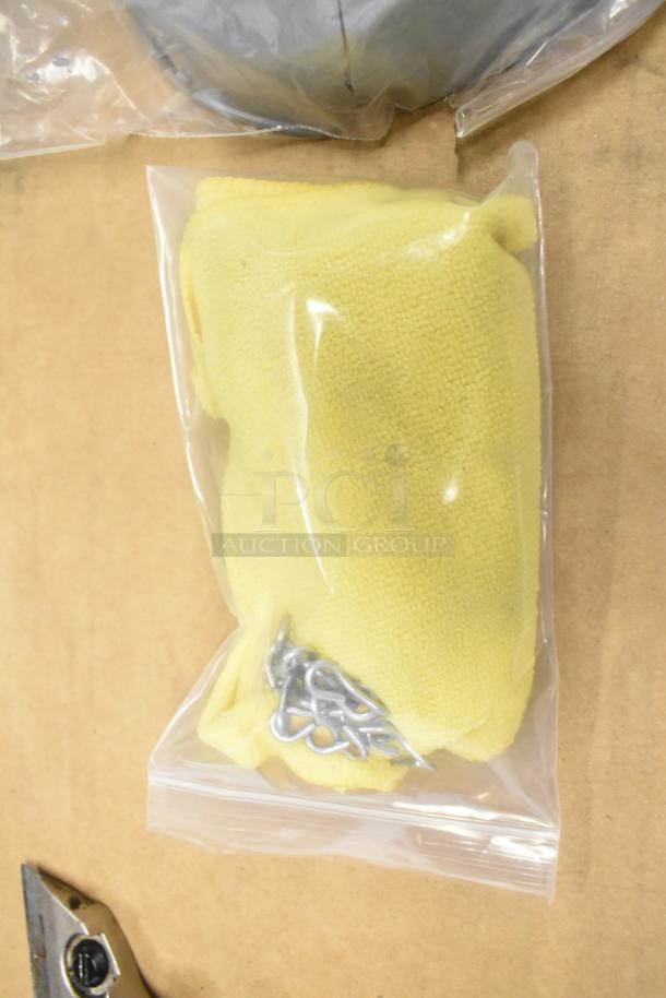 Bag with yellow cover and metal chain, brand new with minor scratches, sealed in clear packaging.