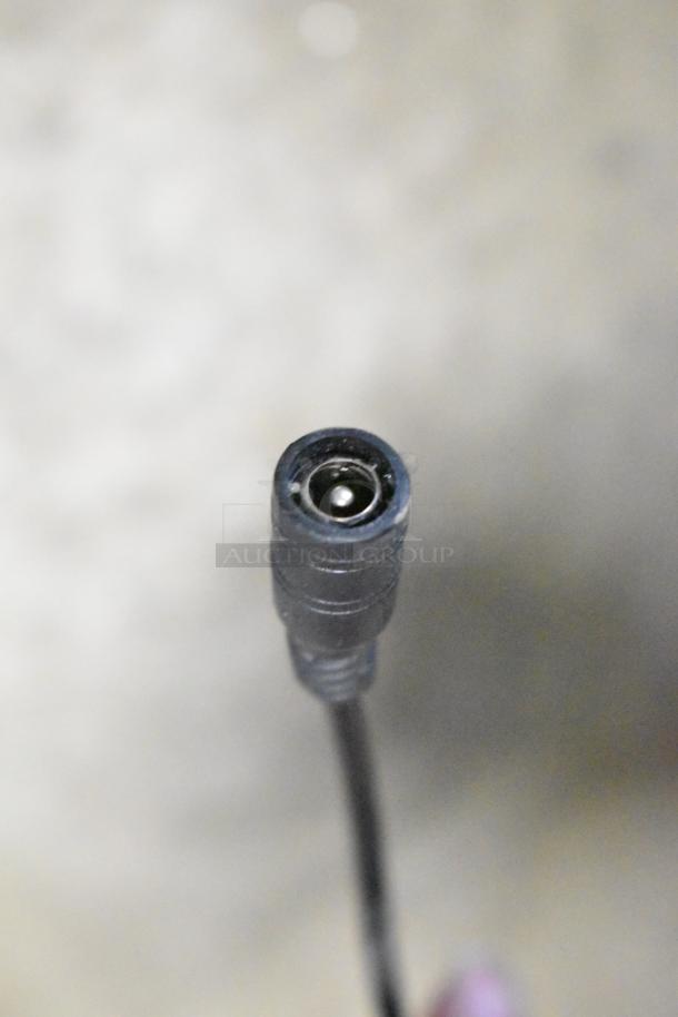 "Black power connector for Cima Light, 120 volts, 1 phase. Brand new condition with visible scratches."