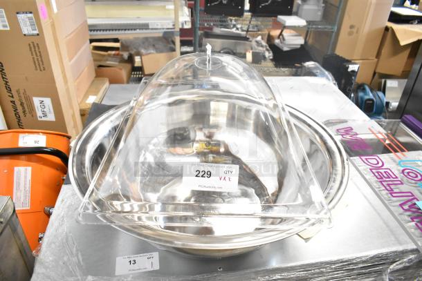 Brand new metal bowl with a clear poly lid, labeled "229 QTY VAZ" from PCIAuctions, sold as scratch and dent.