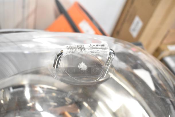 Brand new metal bowl with poly clear lid, visible warning label on handle. Scratch and dent condition. Auction item.