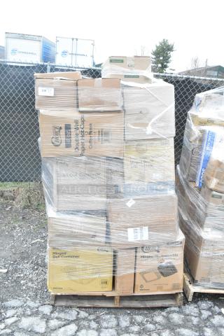 Stack of 34 new items including napkins, containers, toilet paper, and cups on wooden pallet. Some boxes labeled "Hinged Deli Container" and "Disposable Cups," shrink-wrapped for auction.