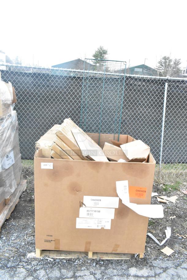 Cardboard box with scratch and dent items, including table base pieces and a waitress stand, labeled "Chicken" and "4577718150."