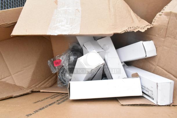 Cardboard box with 17 brand new, scratch and dent items, including table base pieces and a waitress stand.