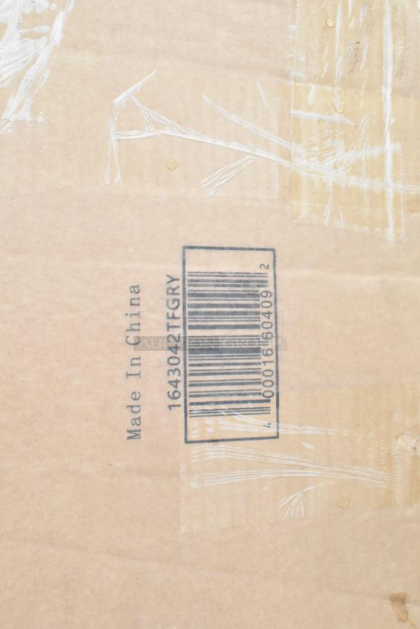 Cardboard box with a barcode and “Made in China” text, containing new scratch and dent items like table base pieces and waitress stand.