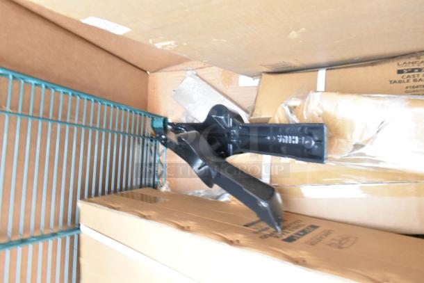 Assorted new scratch and dent items, including table base pieces and waitress stand. Boxes labeled "Lanconic Cast Iron Table Base."