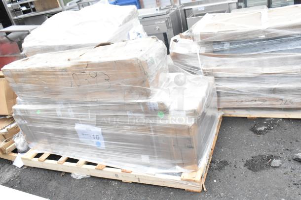 Four brand new scratch and dent items, including a work table, wrapped on pallets. Auction label visible, "MAR26-16."
