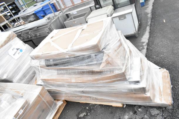 Pallet with 11 brand new scratch and dent items, including strip warmers, glass rack, and Regency shelf, wrapped in plastic.