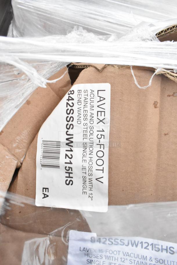 Auction lot of 11 brand new, scratch and dent items including strip warmers, glass rack, Regency shelf. Labels show "Lavex 15-foot vacuum and solution hoses with 12-inch stainless steel single jet single bend wand".