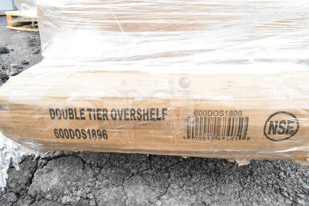 Cardboard box containing a double-tier overshelf, marked "600DOS1896" and "NSF," wrapped in plastic, part of a scratch and dent auction lot.
