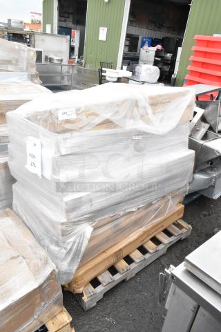 Shrink-wrapped pallet with eight brand new items, including umbrellas, marked as scratch and dent. Labels visible.