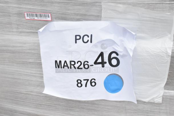 Wrapped pallet with a paper label reading "PCI MAR26-46 876" and a barcode indicating shipping details.