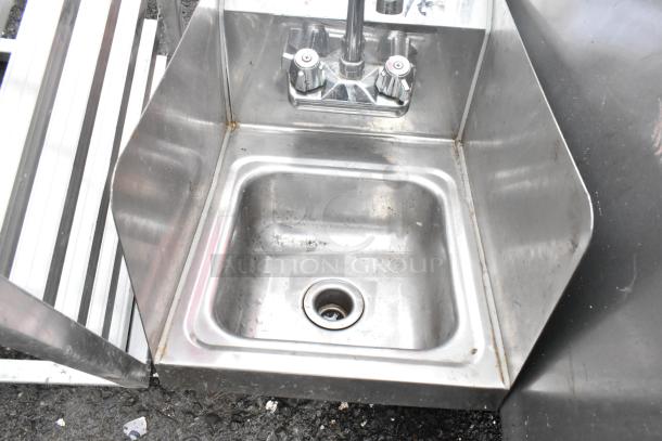 Regency 600HS12SP 12"x16" stainless steel wall-mounted hand sink with gooseneck faucet and side splash in used condition.