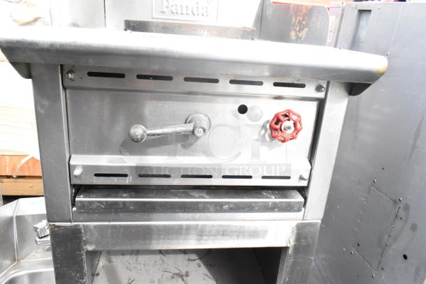 Panda gas-powered single burner wok range, stainless steel, with control knobs and Panda logo. Good condition.