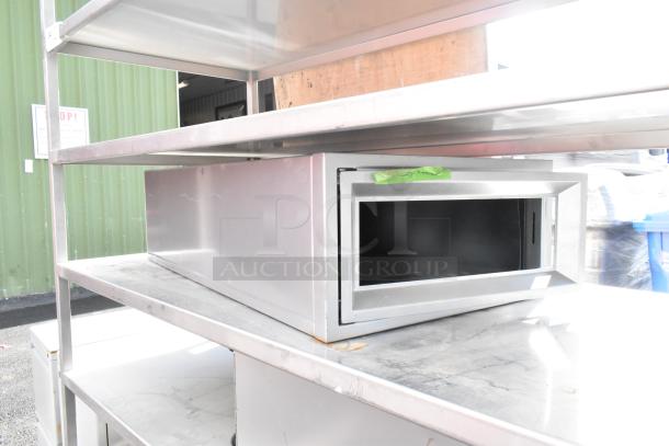 Commercial 7 tier shelving unit with contents, on commercial casters. Metal construction, good condition, suitable for storage.