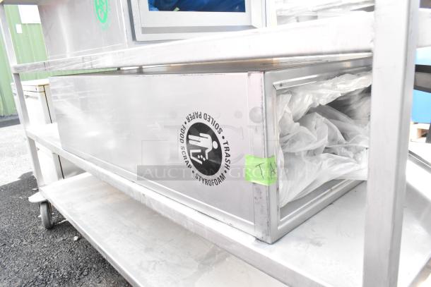 Commercial 7-tier shelving unit with contents on casters. Stainless steel, features a trash label, and a green tag marked "TA."