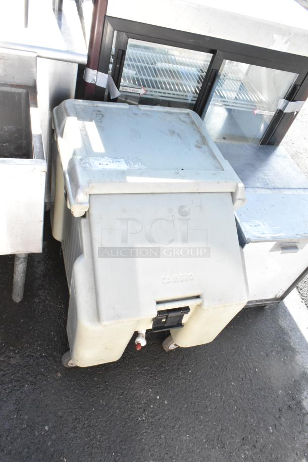 Cambro Poly Portable Ice Bin on casters, visible wear, with branded logo. Durable and mobile for commercial use.