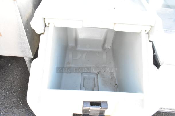 Cambro Poly Portable Ice Bin with commercial casters, open top view, shows interior condition, sturdy design for mobility.