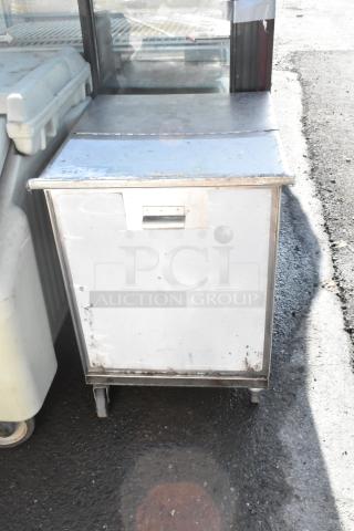 Dish cart on commercial casters, metal construction, used condition, visible wear and rust on exterior.